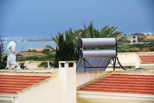 Solar boilers for water heating on the roofs of houses. Solar heated water.