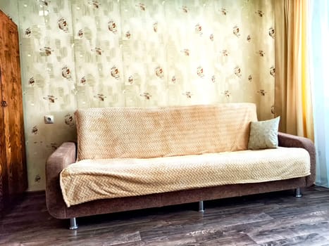 Vintage Soviet-Era Living Room With Classic Furnishings and Decor. Vintage room featuring Soviet-style sofa and typical interior decoration