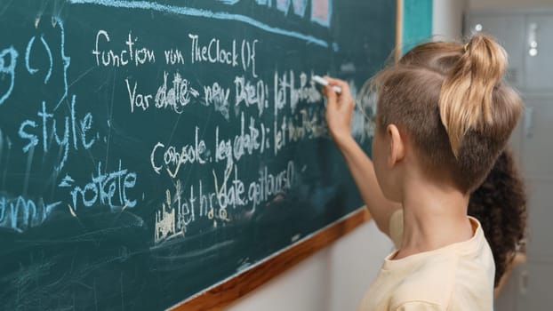 Diverse student studying coding engineering prompt while writing answer on blackboard. Intelligence children planning and learning about coding development plan. Successful boy sharing idea. Pedagogy.