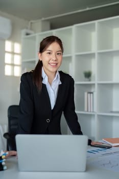 Young successful employee or business woman at desk at office. Achievement career concept.