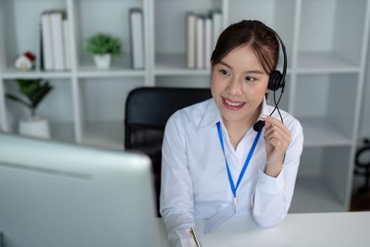 Call center woman asian in office for customer service, technical support and advice, contact and communication with employee operator in help desk agency.
