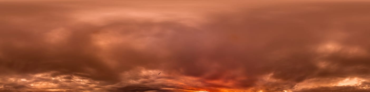 Dramatic Sunset sky 360 panorama. Vibrant sky with bright glowing red pink Cumulus clouds. HDR 360 seamless spherical panorama. Sky dome for aerial drone panoramas. Climate and weather change