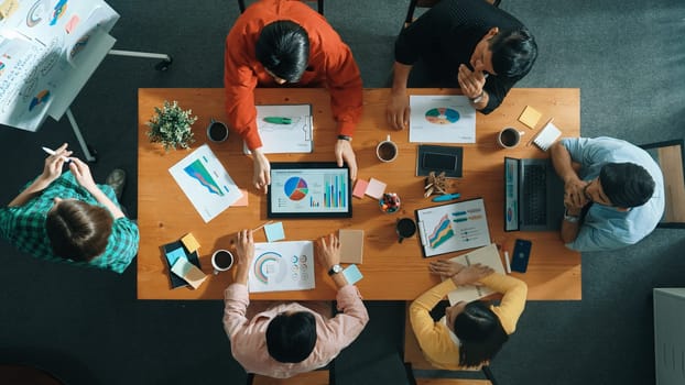 Top view of businesswoman hold tablet display financial graph and place on meeting table with sticky notes. Project manager looking at stock market statistic and analyzing data analysis. Convocation.