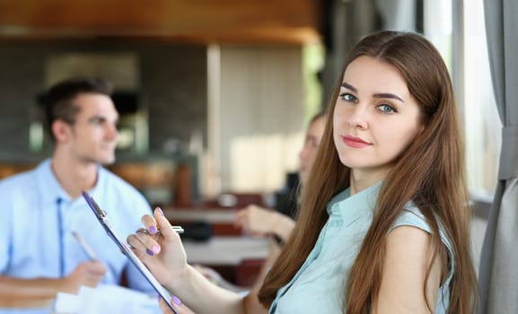 young beautiful woman have meeting with her subordinates in cafe