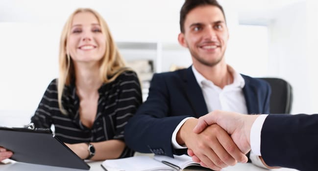 Smiling arab man in suit shake hands as hello in office portrait. Friend welcome mediation offer positive introduction greet or thanks gesture summit participate approval strike arm bargain concept