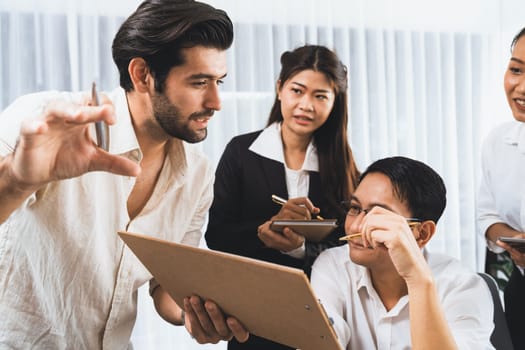 Group of diverse office worker employee working together on strategic business marketing planning in corporate office room. Positive teamwork in business workplace concept. Prudent