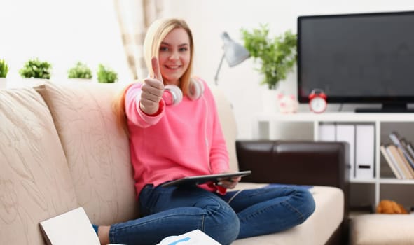 young pretty blond woman hold tablet in arms show big finger super enjoy study concept