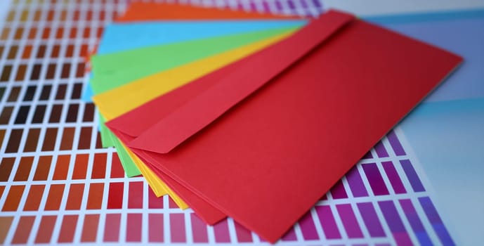 Set of colourful envelopes lying in fantail shape closeup