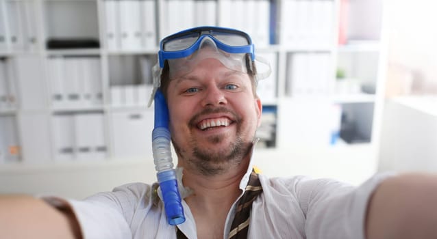 Man wearing suit and tie in goggles and snorkel make selfie with cellphone at office ready to take off portrait. Count days to leave annual day off workaholic freedom fun tourism resort idea concept