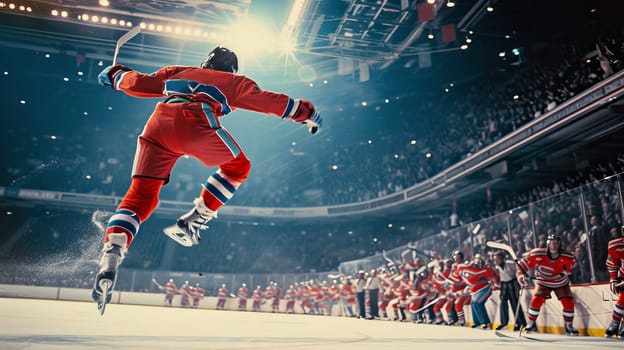 A hockey player in a red jersey leaps joyfully after scoring a goal, with the crowd cheering in the background