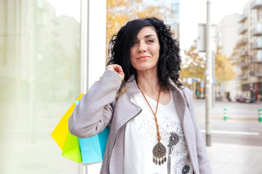 Woman shopping. Happy woman with shopping bags enjoying shopping. Consumerism, shopping, lifestyle concept