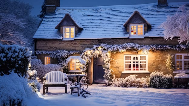 Christmas in the countryside, cottage and garden decorated for holidays on a snowy winter evening with snow and holiday lights, English country styling inspiration