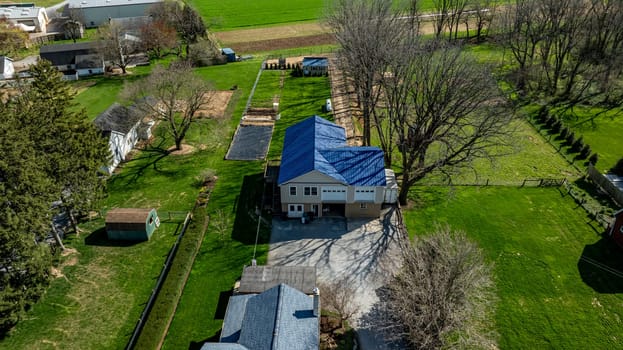 Gordonville, Pennsylvania, USA, April 9, 2024 - Aerial View Capturing A Residential Property Surrounded By Trees And Green Lawns.