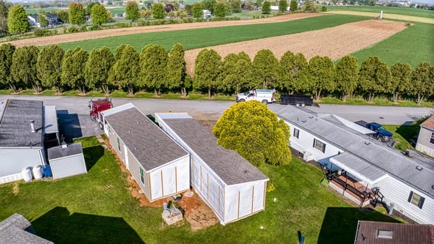 An Aerial View of a Manufactured, Mobile, Prefab Double Wide Home Being Installed in a Lot in a Park