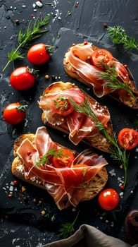 Three slices of bruschetta topped with cured prosciutto, fresh cherry tomatoes, and dill, garnished with spices, on a dark slate surface.