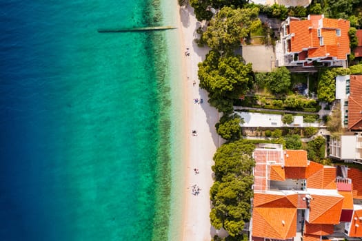 Beautiful Brela on Makarska riviera, Croatia. Adriatic Sea with amazing turquoise clean water and white sand. Aerial view of Brela beach and waterfront on Makarska riviera, Dalmatia region of Croatia.