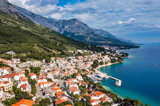 Beautiful Brela on Makarska riviera, Croatia. Adriatic Sea with amazing turquoise clean water and white sand. Aerial view of Brela town and waterfront on Makarska riviera, Dalmatia region of Croatia.