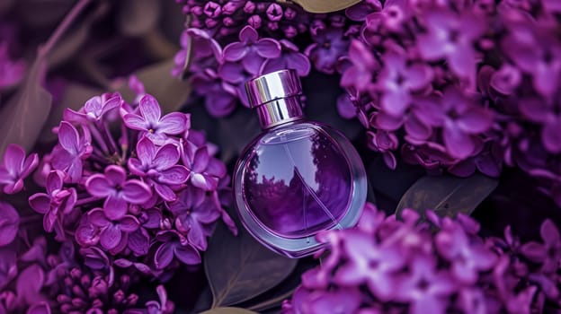 Perfume bottle in flowers, fragrance on blooming background, floral scent and cosmetic product idea