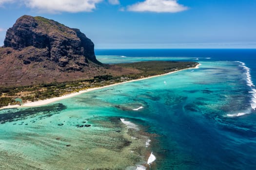Aerial view of Mauritius island panorama and famous Le Morne Brabant mountain, beautiful blue lagoon and underwater waterfall. Aerial view of Le morne Brabant in Mauriutius.