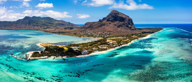 Aerial view of Le morne Brabant in Mauriutius. Tropical crystal ocean with Le Morne mountain and luxury beach in Mauritius. Le Morne beach with palm trees, white sand and luxury resorts, Mauritius.