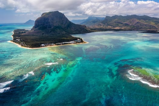 Aerial view of Mauritius island panorama and famous Le Morne Brabant mountain, beautiful blue lagoon and underwater waterfall. Le Morne Brabant peninsula and Underwater Waterfall, Mauritius.
