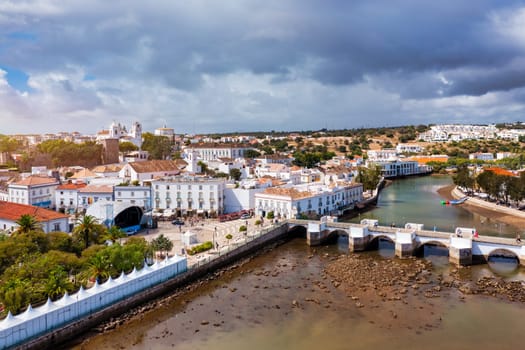 View on historic town of Tavira with Roman bridge over River Gilao, Algarve, Portugal. Cityscape of the Tavira old town with Clock tower, St Marys church, Algarve region, Portugal. 