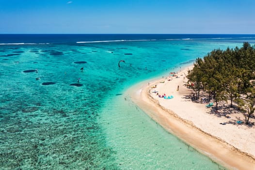 Kitesurfers, windsurfers on the Le Morne beach, famous aquatic sports spot in Mauritius island. Kite surfing in the clear waters of the Indian Ocean in Le Morne beach, Mauritius.