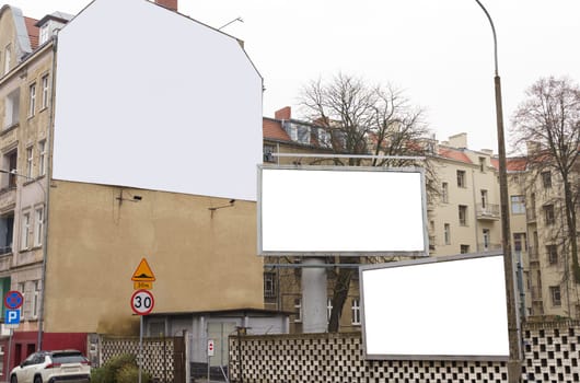 Two billboards positioned on the side of a road, showcasing advertising content on a white background mockup.