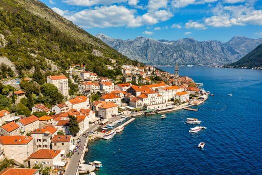 View of the historic town of Perast at famous Bay of Kotor on a beautiful sunny day with blue sky and clouds in summer, Montenegro. Historic city of Perast at Bay of Kotor in summer, Montenegro.