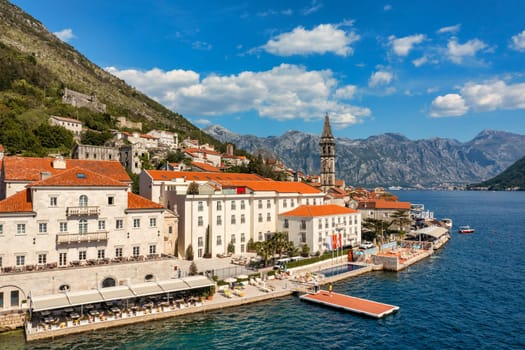 View of the historic town of Perast at famous Bay of Kotor on a beautiful sunny day with blue sky and clouds in summer, Montenegro. Historic city of Perast at Bay of Kotor in summer, Montenegro.