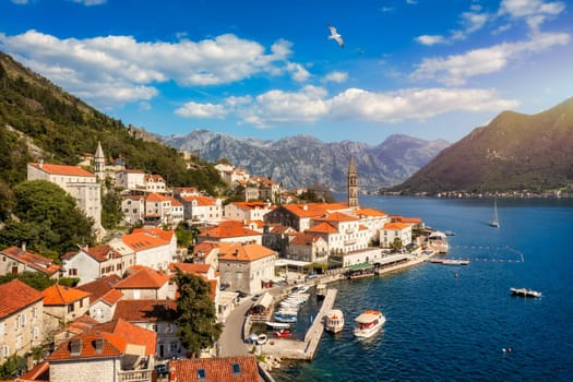 View of the historic town of Perast at famous Bay of Kotor on a beautiful sunny day with blue sky and clouds in summer, Montenegro. Historic city of Perast at Bay of Kotor in summer, Montenegro.
