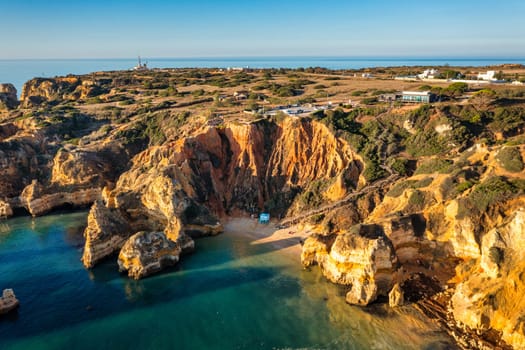 Camilo beach (Praia do Camilo) in Lagos, Algarve, Portugal. Wooden footbridge to the beach Praia do Camilo, Portugal. Picturesque view of Praia do Camilo beach in Lagos, Algarve region, Portugal.