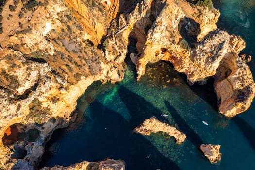 Panoramic view, Ponta da Piedade near Lagos in Algarve, Portugal. Cliff rocks and tourist boat on sea at Ponta da Piedade, Algarve region, Portugal. Ponta da Piedade, Algarve region, Portugal.