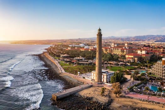 Lighthouse of Maspalomas at Gran Canaria Island known as Faro de Maspalomas at sunset. Seascape with lighthouse and Maspalomas beach. Gran Canaria, Canary Islands, Spain