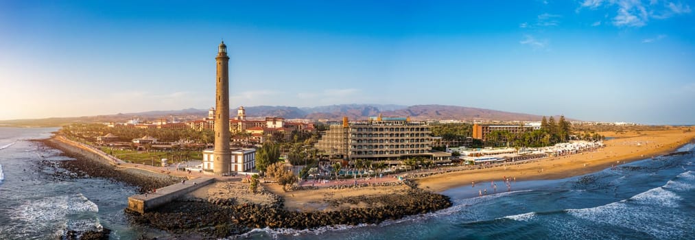 Lighthouse of Maspalomas at Gran Canaria Island known as Faro de Maspalomas at sunset. Seascape with lighthouse and Maspalomas beach. Gran Canaria, Canary Islands, Spain