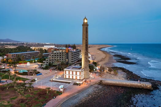 Lighthouse of Maspalomas at Gran Canaria Island known as Faro de Maspalomas at sunset. Seascape with lighthouse and Maspalomas beach. Gran Canaria, Canary Islands, Spain