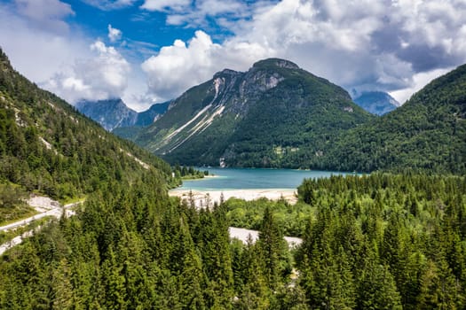 View to Julian Alps mountains above Predil lake in Italy with small lake. Predil Lake, Friuli Italy / (Lago del Predil), beautiful alpine lake in north Italy near the Slovenian border, Italy.