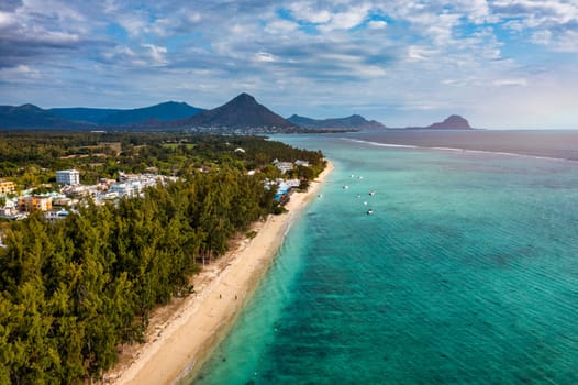 Beautiful Mauritius island with beach Flic en flac. Coral reef around tropical palm beach, Flic en Flac, Mauritius. Aerial view of a beautiful beach along the coast in Flic en Flac, Mauritius.