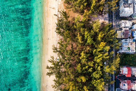 Beautiful Mauritius island with beach Flic en flac. Coral reef around tropical palm beach, Flic en Flac, Mauritius. Aerial view of a beautiful beach along the coast in Flic en Flac, Mauritius.