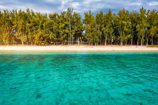 Beautiful Mauritius island with beach Flic en flac. Coral reef around tropical palm beach, Flic en Flac, Mauritius. Aerial view of a beautiful beach along the coast in Flic en Flac, Mauritius.