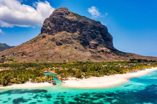 Aerial view of Le morne Brabant in Mauriutius. Tropical crystal ocean with Le Morne mountain and luxury beach in Mauritius. Le Morne beach with palm trees, white sand and luxury resorts, Mauritius.
