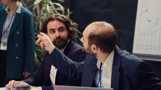 Startup team reviewing the organization position within the market, conducting an analysis or benchmarking exercises. Enterprise colleagues discuss activities for organizational growth. Camera A.