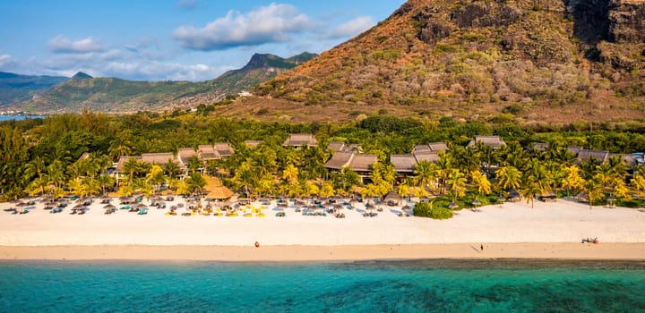 Aerial view of Le morne Brabant in Mauriutius. Tropical crystal ocean with Le Morne mountain and luxury beach in Mauritius. Le Morne beach with palm trees, white sand and luxury resorts, Mauritius.