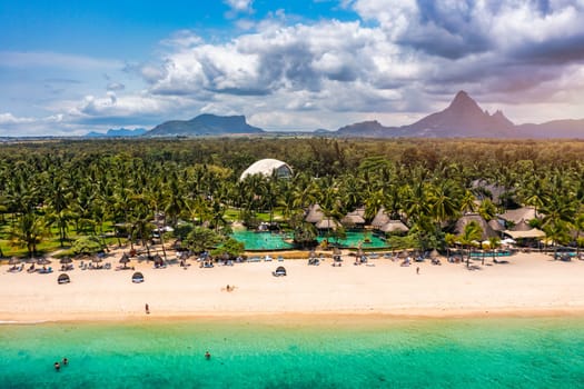 Beach of Flic en Flac with beautiful peaks in the background, Mauritius. Beautiful Mauritius Island with gorgeous beach Flic en Flac, aerial view from drone. Flic en Flac Beach, Mauritius Island.