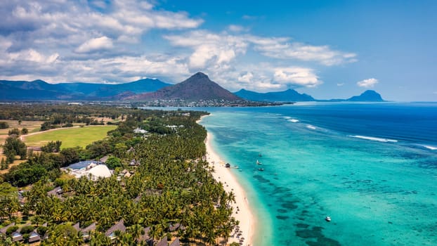 Beach of Flic en Flac with Piton de la Petite Riviere Noire Mauritius. Beautiful Mauritius Island with gorgeous beach Flic en Flac, aerial view from drone. Flic en Flac Beach, Mauritius Island.