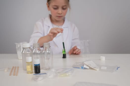 Caucasian girl doing chemical experiments on a white background