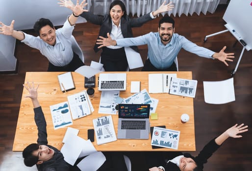 Top view office worker celebrate in meeting room, throwing paperwork in the air. Excitement and freedom expression from business people throw analysis financial paper in celebratory gesture. Concord