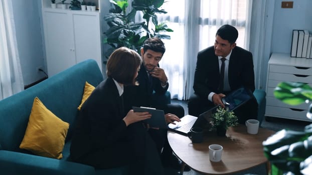 Top view of diverse business team planning marketing strategy at meeting room. Professional manager thinking and analyze stock investment chart from laptop while colleague sharing idea. Directorate.