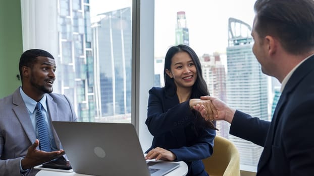 Ornament office with cityscape view, business college or corporate consultant greeting with handshake or shake hand after seal corporate agreement deal for business partnership cooperation