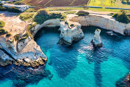 Stunning seascape with cliffs rocky arch and stacks (Faraglioni) at Torre Sant Andrea, Salento coast, Puglia region, Italy. Beautiful cliffs and sea stacks of Sant'Andrea, Salento, Apulia, Italy